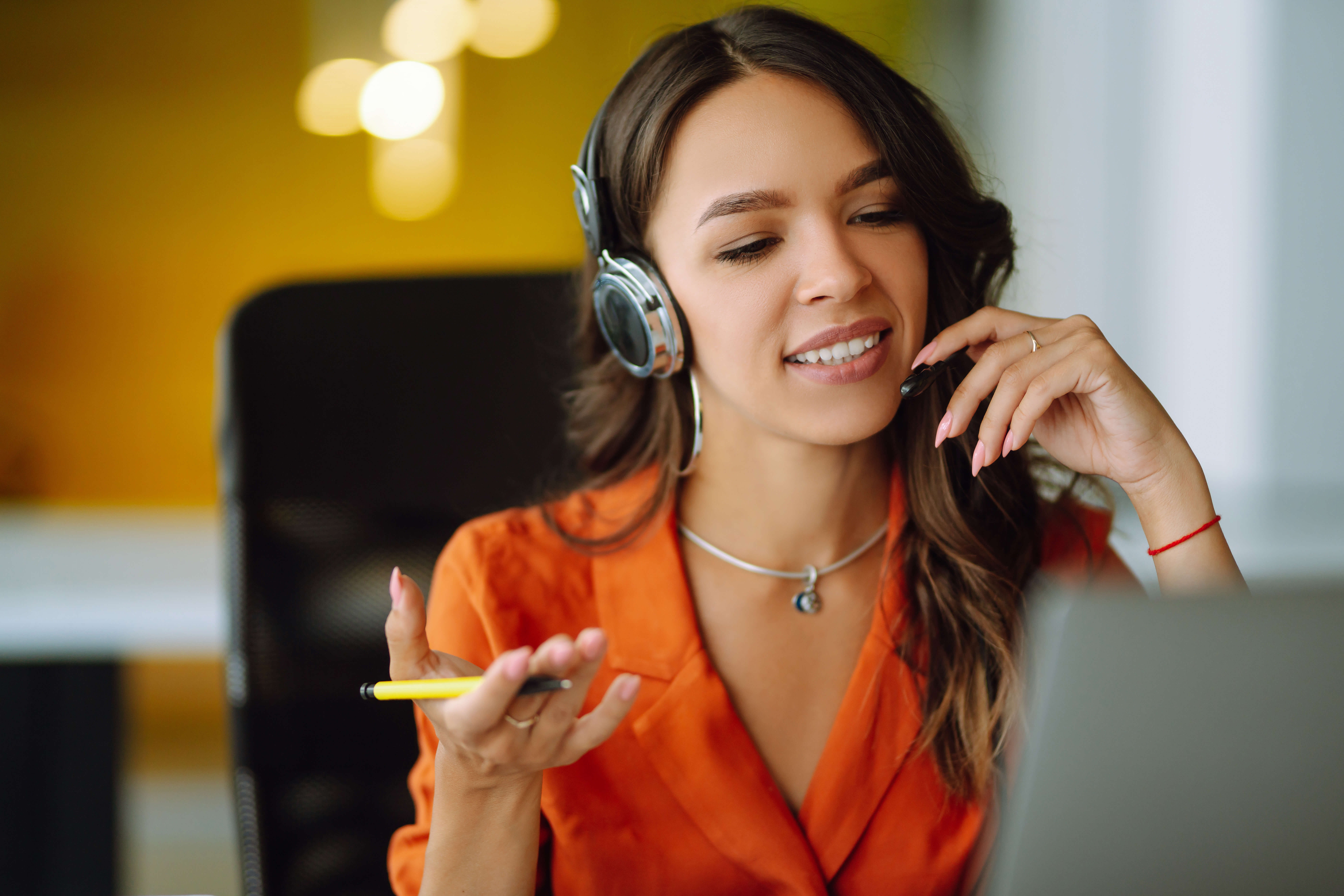 Young operator woman agent with headsets working in a call center